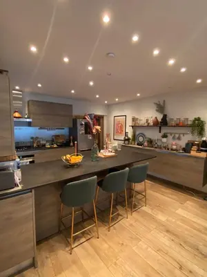 a kitchen with a table and chairs in a room at Quiet villa Exceptional view and its exterior in Liège