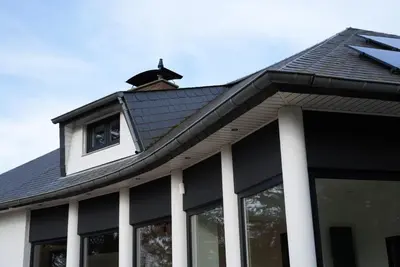 a house with a black roof with a dormer at Min Su in Waremme