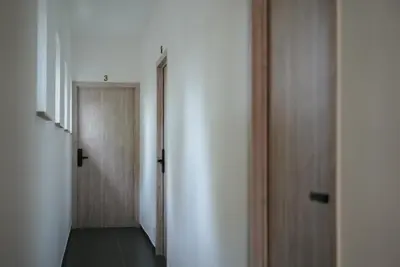 an empty hallway with a door and a hallway at Min Su in Waremme