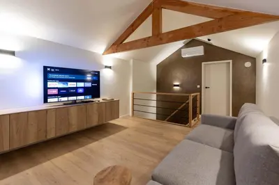 a living room with a couch and a flat screen tv at Villa Armande in Zammelen