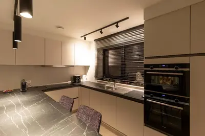 a kitchen with a table and chairs in it at Villa Armande in Zammelen