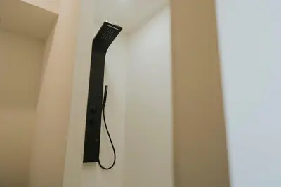 a black toothbrush hanging on a wall at 2 bedroom apartment near the city center in Liège
