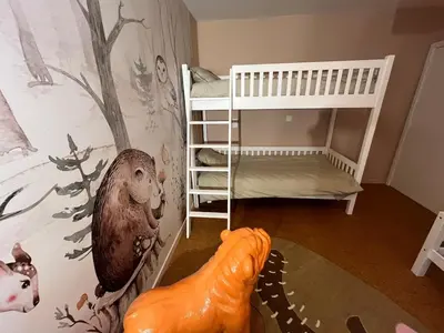 a childs bedroom with a monkey and a crib at Ardilla - holiday house in an oasis of green in Heusden - Zolder
