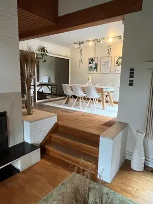 a living room with a table and a dining room at Ardilla - holiday house in an oasis of green in Heusden - Zolder