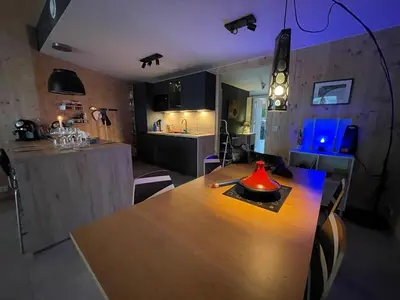 a kitchen with a table with a red lamp on it at Appartement tout eco-confort proche du centre in Liège