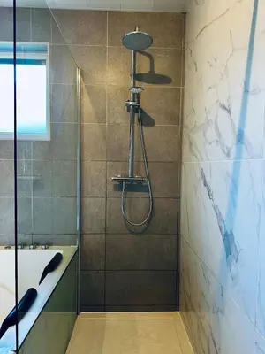 a bathroom with a shower and a tub at Loft de Waroux in Awans