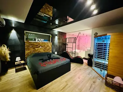 a bedroom with a bed and a rock wall at Loft de Waroux in Awans