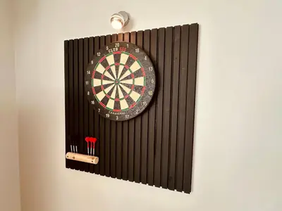 a dart board on a wall with a dartknife at Loft de Waroux in Awans