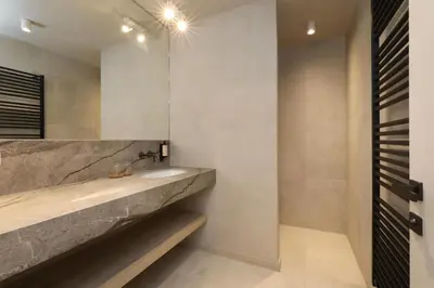 a bathroom with a sink and a concrete counter at Lodge - 4 personen - Woodz Lodges in Heusden - Zolder