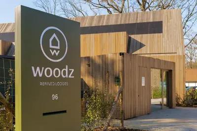a building with a sign in front of it at Lodge - 4 personen - Woodz Lodges in Heusden - Zolder