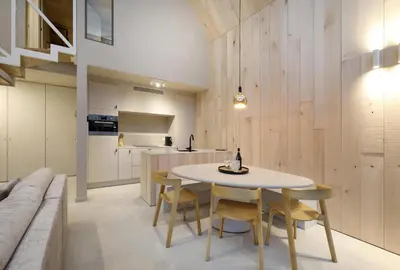a kitchen and dining room with a table and chairs at Lodge met Jacuzzi - 4 personen - Woodz Lodges in Heusden - Zolder