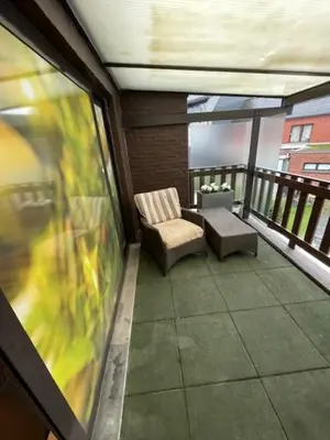 a balcony with a chair and a table at mi casa naranja in Lommel