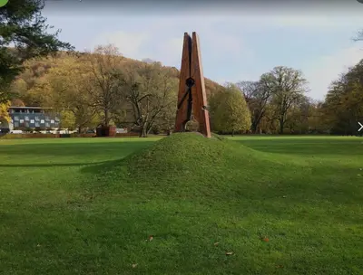 a large wooden sculpture in a field of grass at Ô Gadot in Chaudfontaine