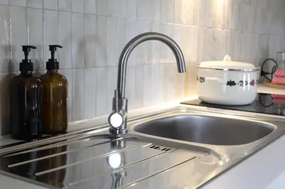 a stainless steel sink in a kitchen with a counter at Vakantiewoning Molenveld in Dilsen-Stokkem