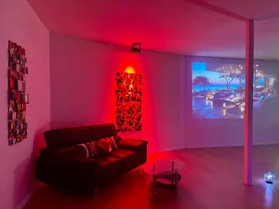 a living room with a couch and a red light at Le Luxe in Fléron