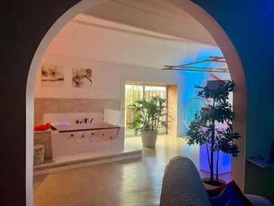 a large bathroom with a tub in an archway at Le Rêve de Narcisse in Fléron