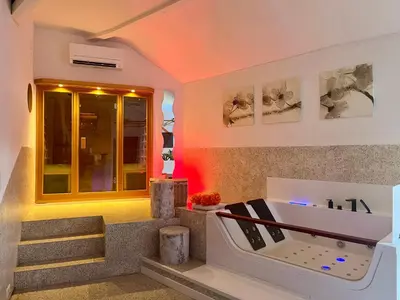 a bathroom with a tub and stairs with lights at Le Rêve de Narcisse in Fléron