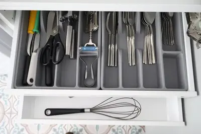 a drawer filled with utensils and a whisk at Le Carlton in Liège