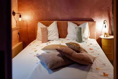 a bedroom with a bed with pillows on it at Sfeervolle B&B in de Voerstreek Lo-Ghis - met Zwembad in Voeren