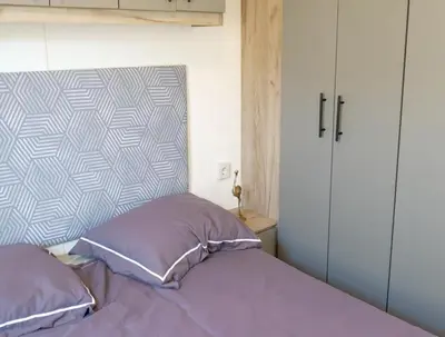 a bed with two pillows in a bedroom at Camping Zavelbos Superior Chalet in Maaseik