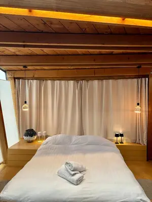 a bedroom with a bed with two towels on it at Art'lette Loft Balneo Bath & Infrared Sauna in Herve