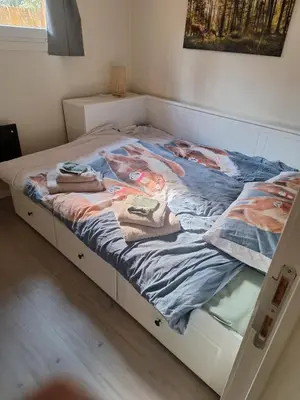 a bed with towels on it in a bedroom at Sakurahuisje in Lanaken