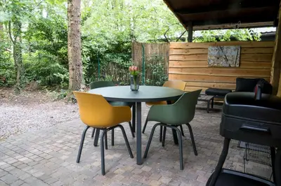 a table and chairs sitting on a patio at Sakurahuisje in Lanaken