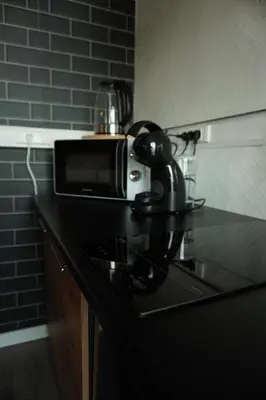 a microwave sitting on top of a counter in a kitchen at ChambreNchill in Seraing