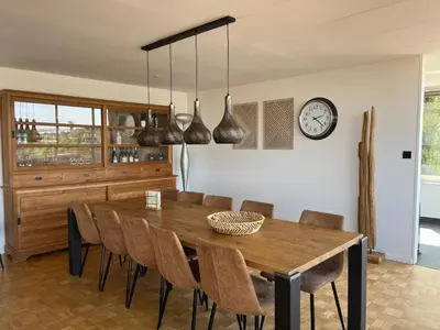 a dining room with a wooden table and chairs at GT Lounge Zolder in Heusden - Zolder