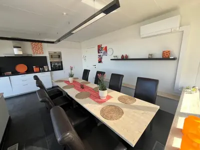 a dining room with a long table and chairs at GT Lounge Zolder in Heusden - Zolder