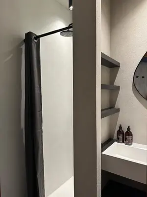 a bathroom with a shower and a white sink at Zalig HASPENGOUW in Sint-Truiden
