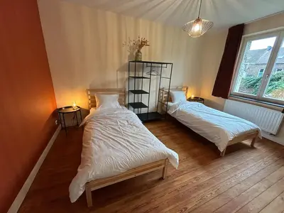 a bedroom with two beds and a window at Vakantiehuis Twenty Six in Hasselt