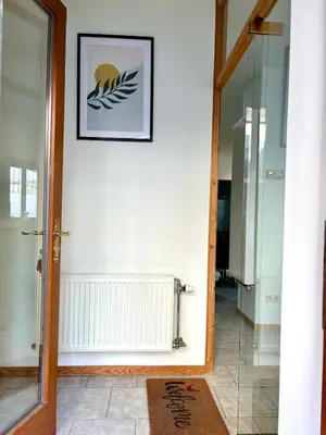 a hallway with a white wall with a picture on it at Aux portes du marché in Verviers