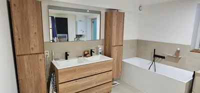 a bathroom with a sink and a mirror at Comme chez Soi in Liège