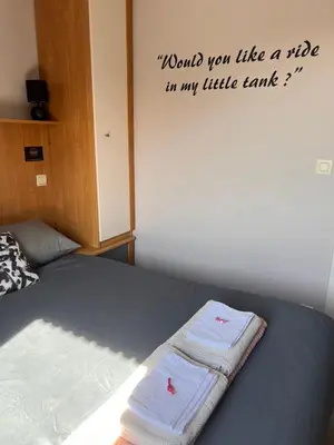 a bedroom with a bed with a towel on it at Klappoel - by Cafe Rene Borgloon in Borgloon