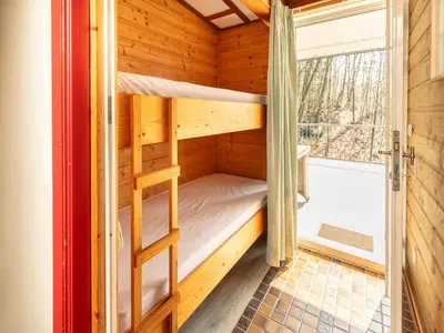 a room with two bunk beds and a window at Holiday Home in Lanklaar near Forest Trails in Lanklaar