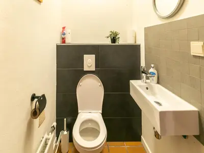 a bathroom with a toilet and a sink at Holiday Home in Lanklaar near Forest Trails in Lanklaar