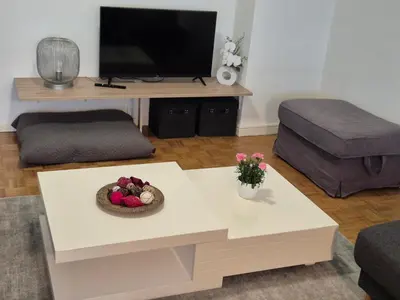 a living room with a coffee table and a tv at Hasselita in Hasselt