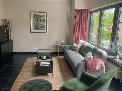 a living room with a couch and a table at Comfortable stay in Tongeren in Tongeren