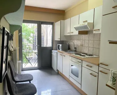 a kitchen with white cabinets and a stove top oven at Comfortable stay in Tongeren in Tongeren