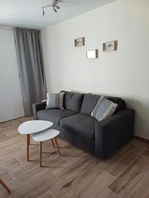 a living room with a black couch and a table at Sunny and bright apartment Kelmis La Calamine Neu Moresnet in La Calamine