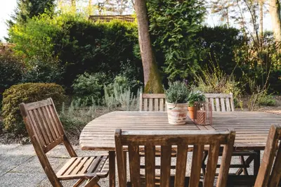 a wooden table and chairs with plants on it at Boshuisje Rekem - Azure in Lanaken