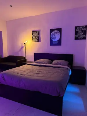 a bedroom with a bed in a purple room at Magnifique appartement moderne in Liège