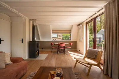 a living room with a couch and a table at Boshuisje Rekem - Ember in Lanaken