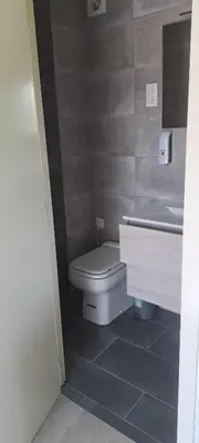 a bathroom with a toilet and a sink at Au coin du hérisson in Olne