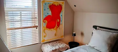 a bedroom with a bed and a window with a picture at 't Herenhoes in Pelt