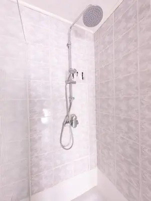 a shower with a shower head in a bathroom at La Cachette d 'Amercoeur in Liège