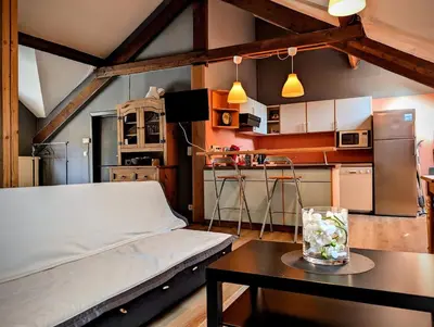 a bedroom with a bed and a table in a room at La Cachette d 'Amercoeur in Liège