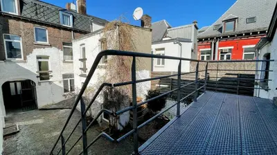 a stairway leading to a building with buildings at La Cachette d 'Amercoeur in Liège