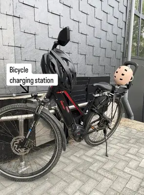 a bike parked next to a bench with a helmet on it at Weserwasser in Eupen